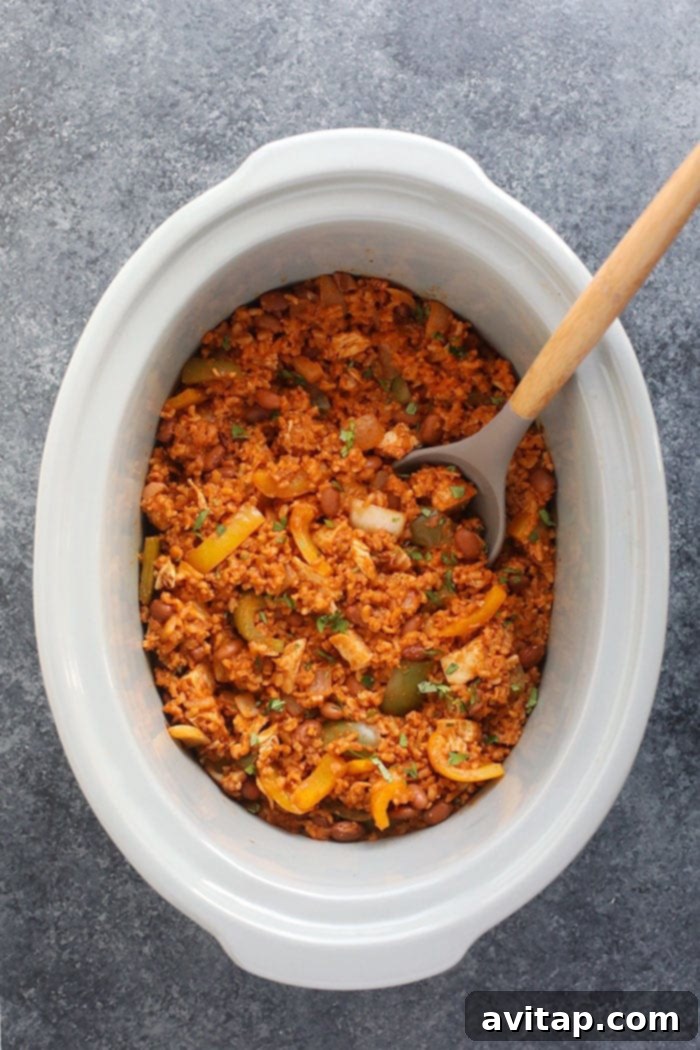 Finished slow cooker enchilada casserole, bubbling and ready to serve, perfect for a busy weeknight.