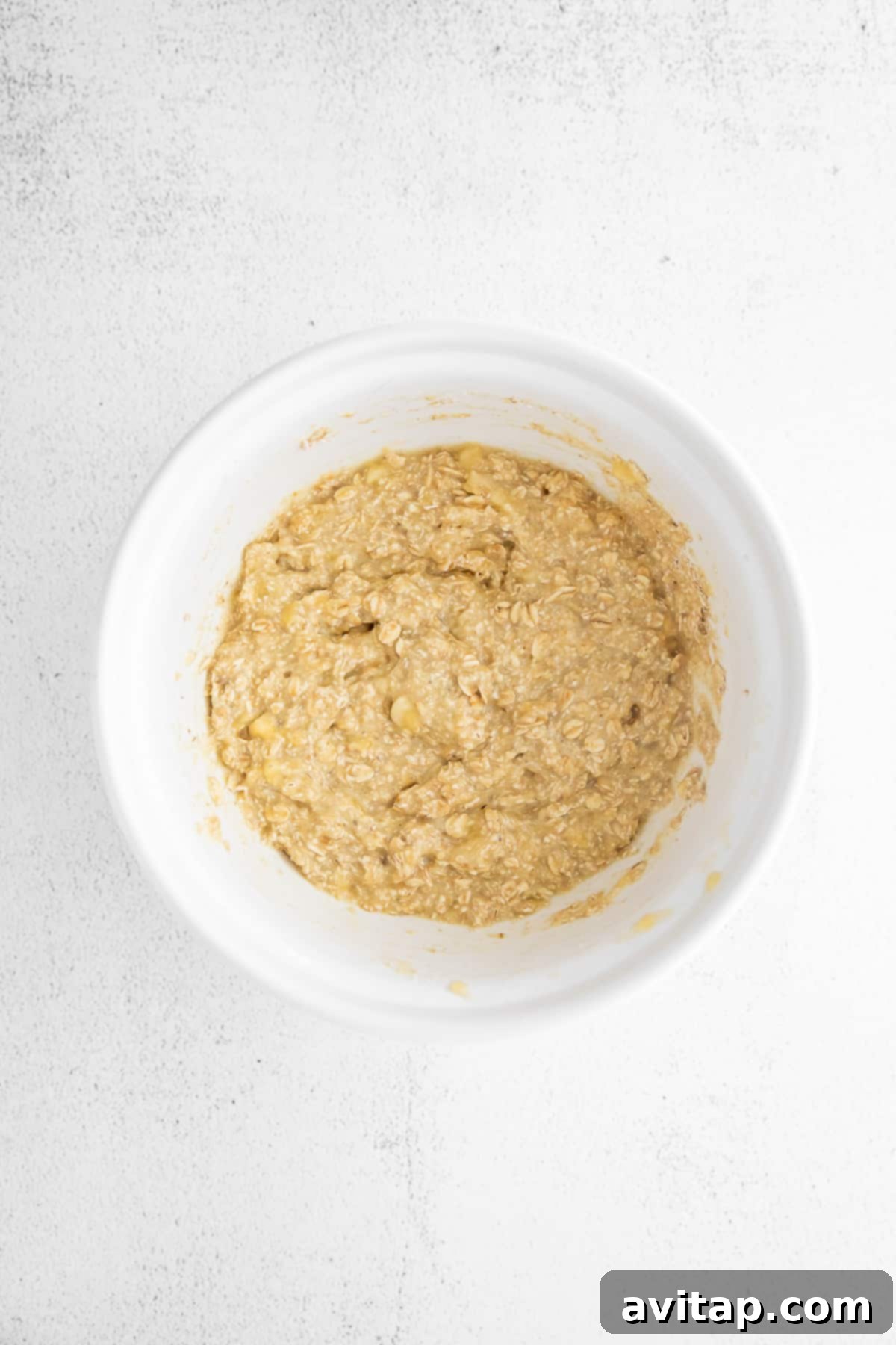 Perfectly Mixed Banana Oatmeal Pancake Batter A bowl of thick, creamy banana oatmeal pancake batter, ready to be cooked.