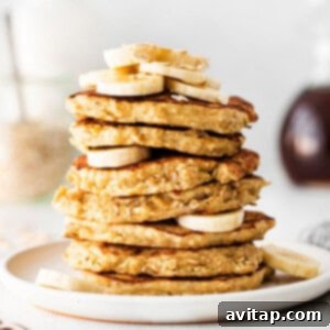 A stack of golden-brown banana oatmeal pancakes, ready to be served.