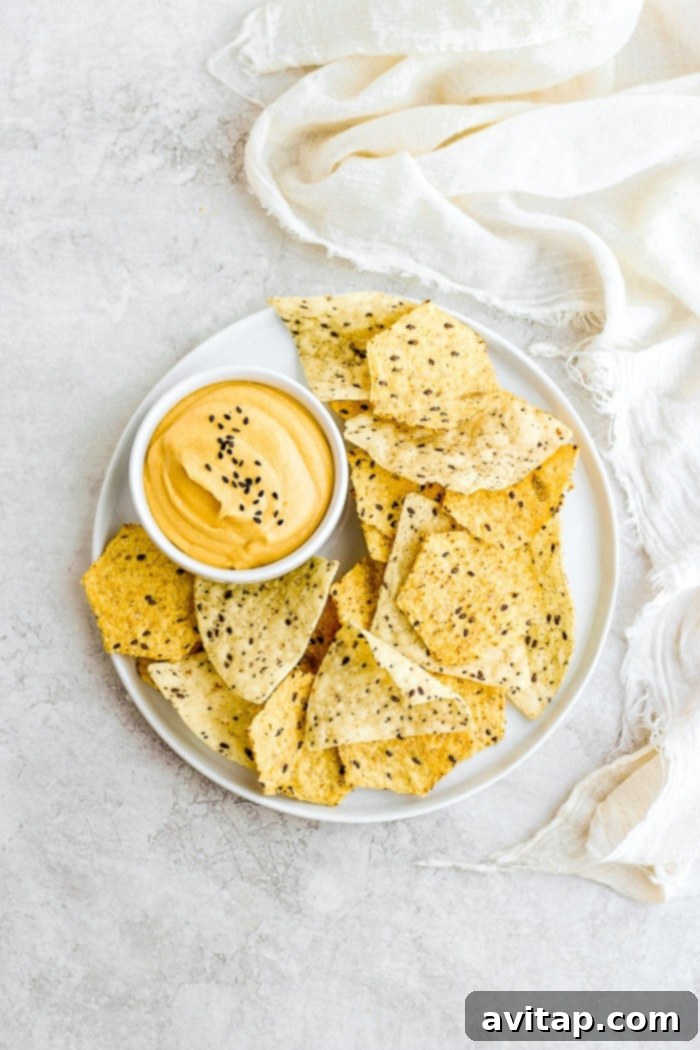 Vegan Cheese Sauce on a plate with tortilla chips, ready for dipping.