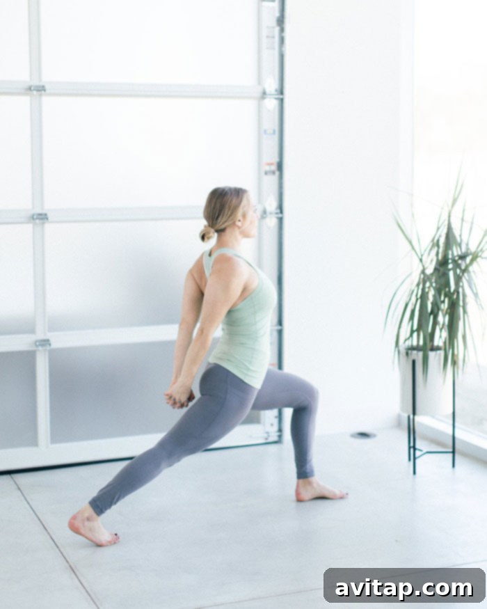 2018 Year in Review 6 Blogger engaging in a new fitness routine, demonstrating a squat at a gym.