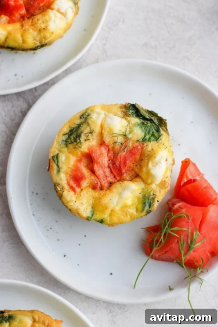 A single smoked salmon breakfast frittata on a white plate, garnished and ready to eat.