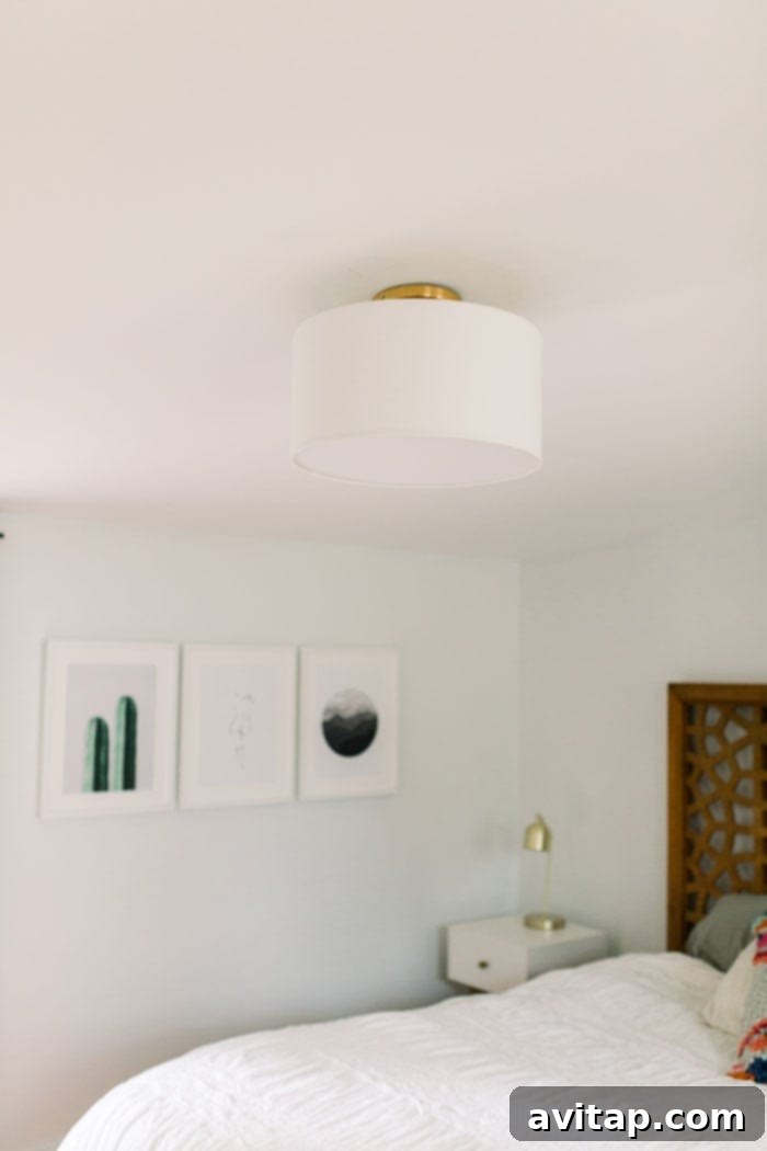 Close-up of a stylish flushmount fabric shade light fixture in a modern bedroom.