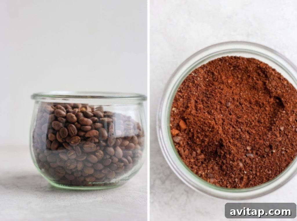 Close-up of fresh, dark roasted coffee beans in a glass jar.