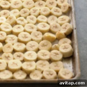 Close-up shot of perfectly frozen banana slices, neatly arranged in a clear freezer bag, showcasing the result of proper freezing