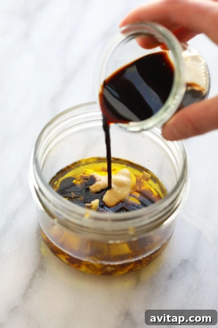 Close-up of freshly made balsamic vinaigrette dressing stored in a classic mason jar, ready for use.