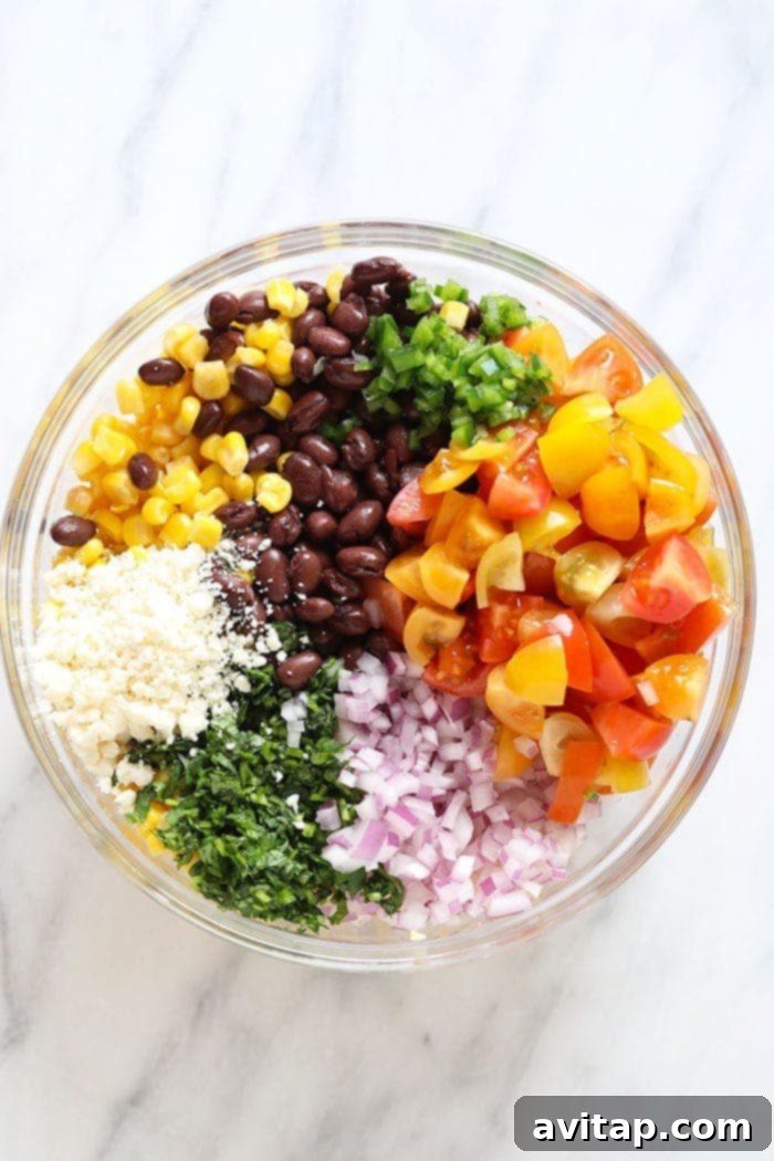 A healthy and refreshing black bean and corn salad, perfect for light meals. Close-up of a healthy, low-fat black bean and corn salad in a glass bowl, showcasing fresh ingredients.