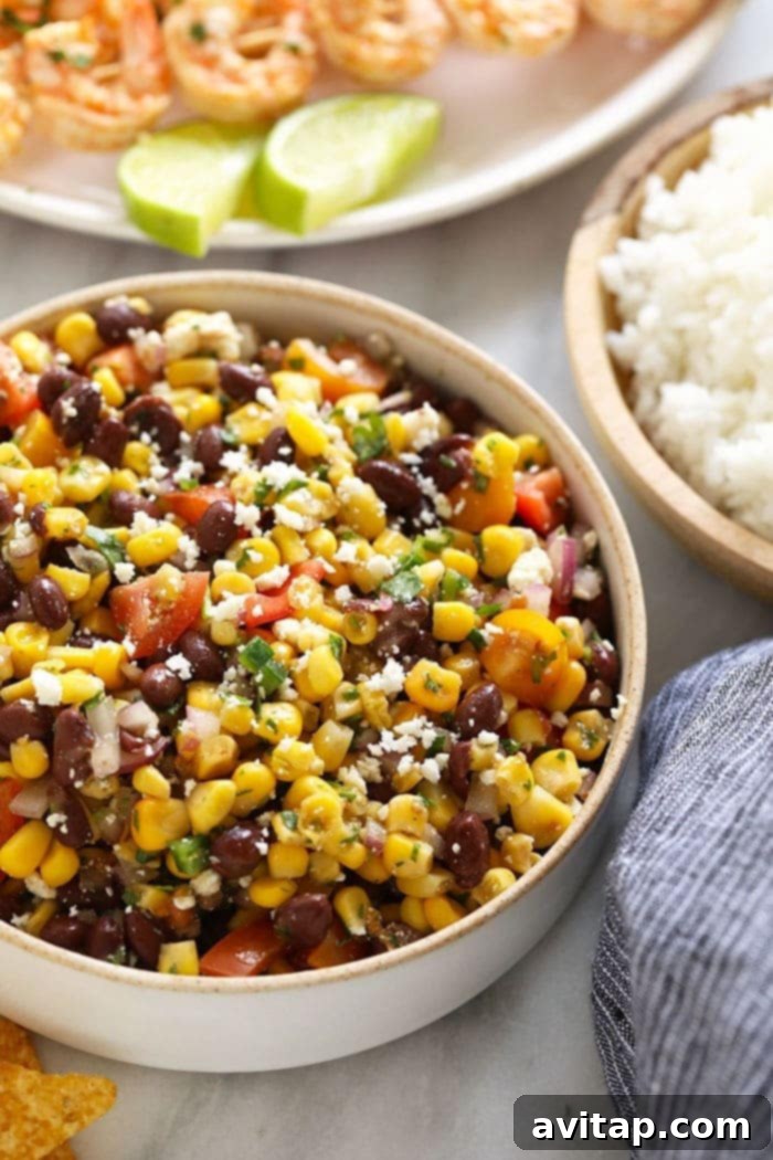 Fresh and limey Black Bean Corn Salad, ready in minutes. Close-up shot of Black Bean Corn Salad in a serving bowl, showcasing its vibrant colors and fresh texture.