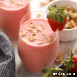 A vibrant strawberry smoothie in a glass, ready to be enjoyed.