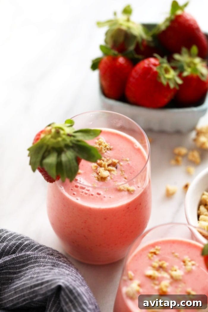 A vibrant strawberry smoothie in a sleek cup, ready to be enjoyed as a healthy and energizing treat.