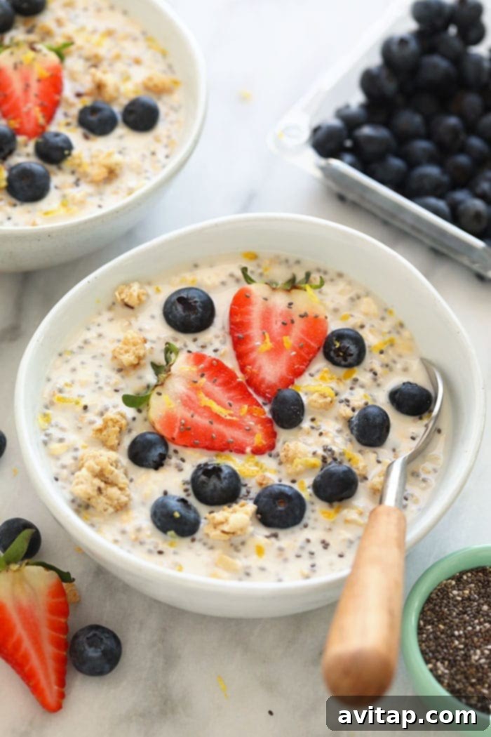 Delicious Lemon Cheesecake Overnight Oats in a glass jar, garnished with fresh lemon slices and mint, ready for a healthy breakfast.