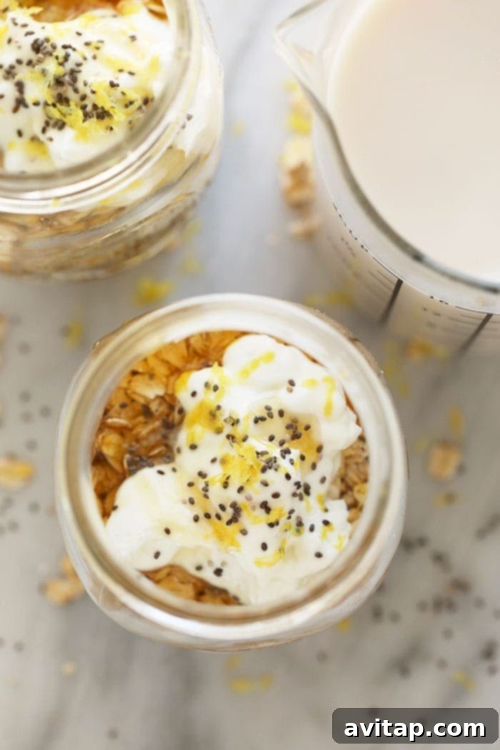 Close-up of a glass jar filled with creamy Lemon Cheesecake Overnight Oats, showing the texture and the appealing blend of ingredients.