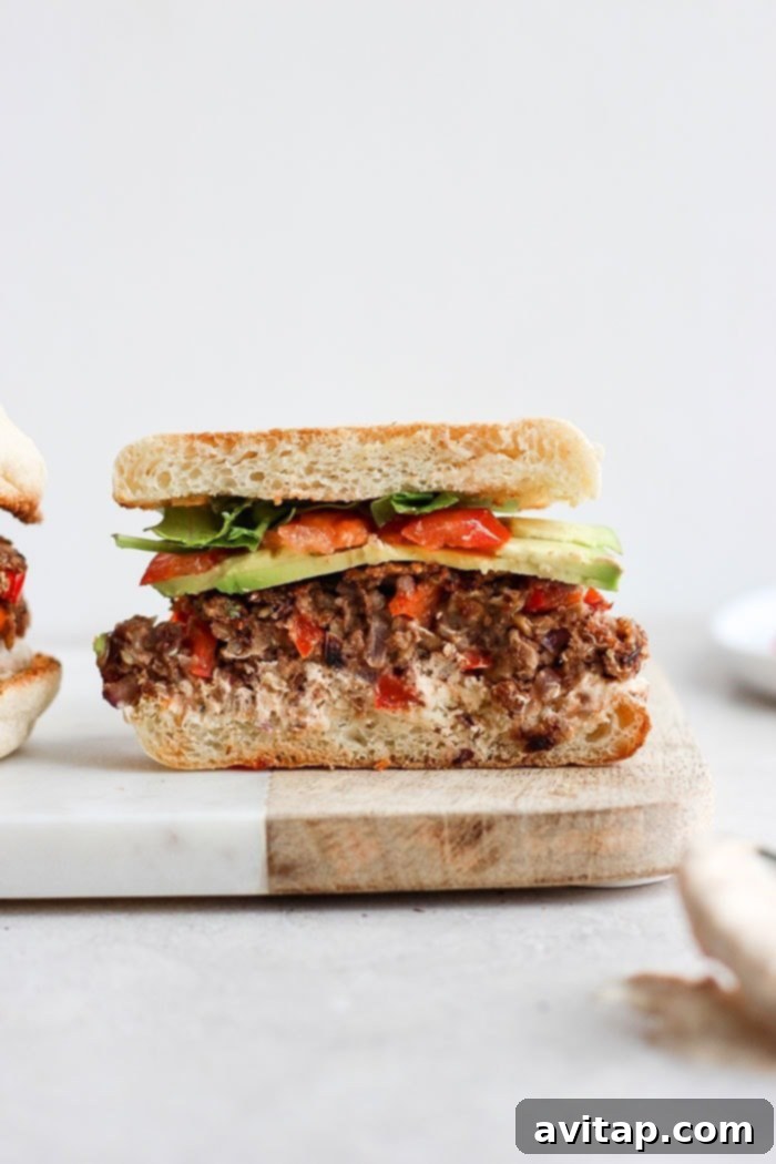 The Most Delicious Black Bean Quinoa Burger Delicious homemade black bean quinoa burger served on an English muffin, topped with fresh ingredients.