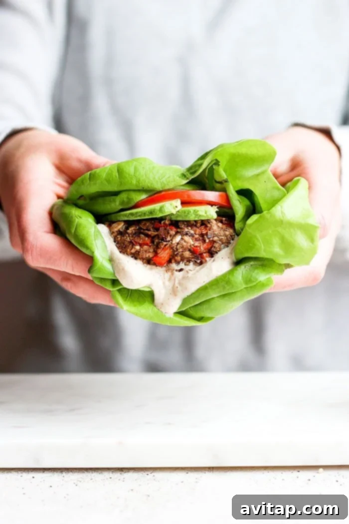 Healthy Black Bean Burger in Butter Lettuce A vibrant black bean burger served in fresh butter lettuce, offering a light and healthy option.