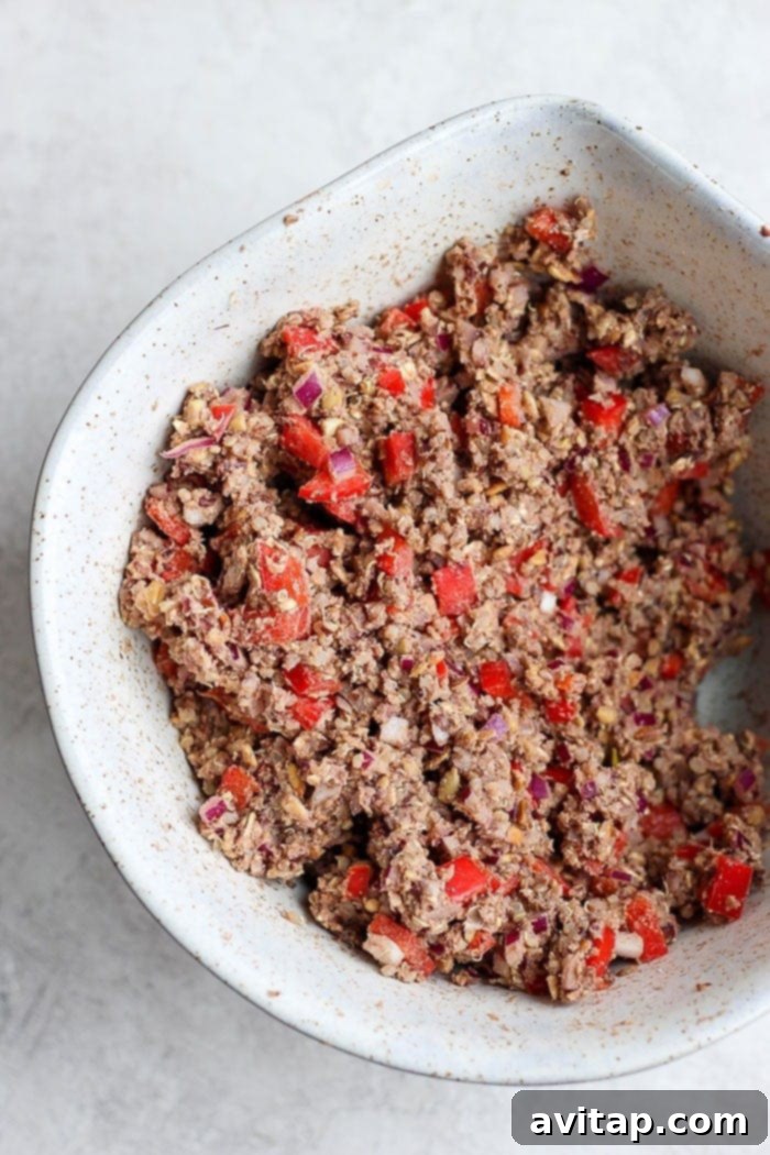 Black Bean Burger Mixture Ready for Patties The blended black bean burger mixture, ready for patty formation, in a white bowl.