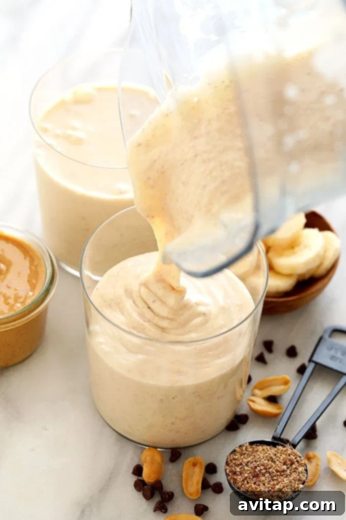 Pouring Smoothie Someone pouring a thick peanut butter banana smoothie into a clear glass.