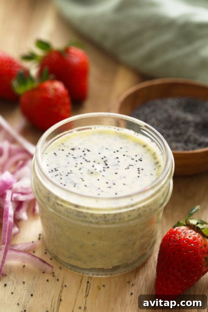 A charming glass jar filled with luscious, creamy homemade poppy seed dressing, perfectly prepared and ready to complement your favorite salads.