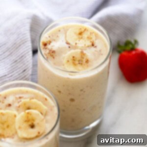 A vibrant, creamy banana smoothie in a glass, ready to be enjoyed.