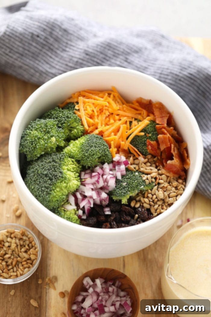 Individual ingredients for healthy broccoli salad with bacon in separate bowls, ready to be mixed.