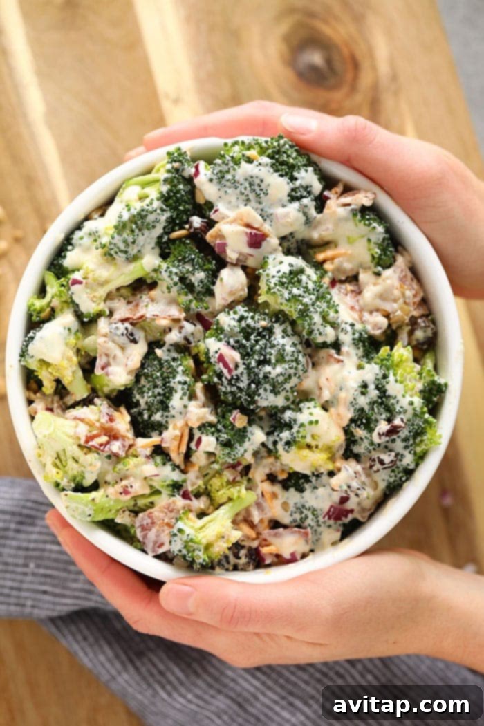 A close-up shot of a large bowl of healthy broccoli salad, showcasing its vibrant ingredients.