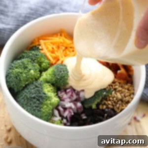 Pouring dressing on broccoli salad.