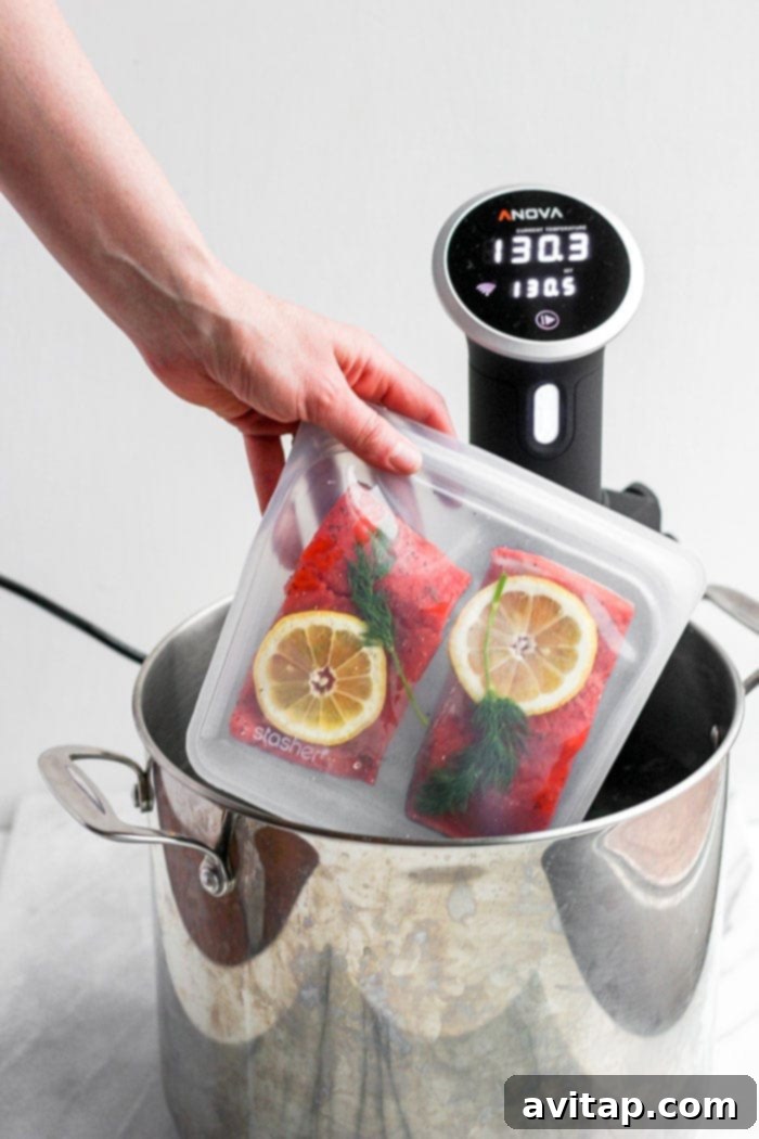 Sous Vide Salmon Setup Sous vide salmon fillets in sealed bags being placed into a water bath.