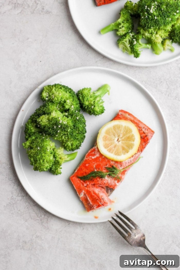 Gourmet Sous Vide Salmon Beautifully plated sous vide salmon with a side of green vegetables, showcasing a healthy and gourmet meal.