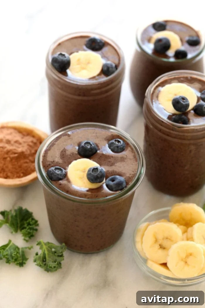 Delicious Superfood Chocolate Protein Smoothie Superfood protein smoothie in a tall glass, garnished slightly.