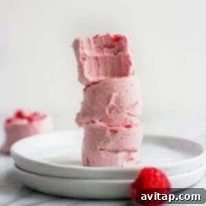 A stack of raspberry fat bombs on a white plate.