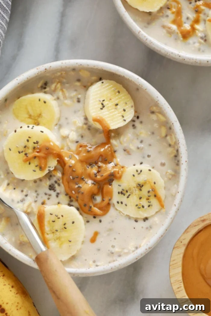 Delicious Creamy Banana Overnight Oats, perfectly garnished. Creamy banana overnight oats in a bowl topped with sliced bananas and chia seeds, ready to eat.