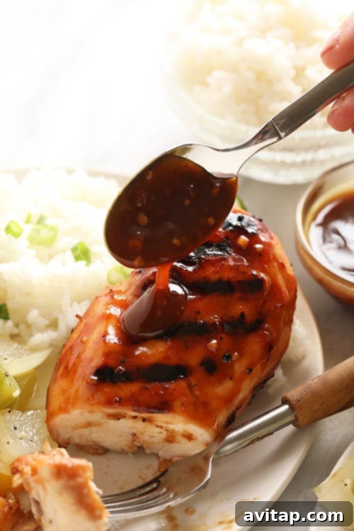 Homemade Teriyaki Sauce on Chicken Delicious homemade teriyaki sauce drizzled over cooked chicken, highlighting its rich color and glaze.