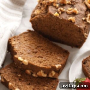 A freshly baked loaf of sliced vegan banana bread ready for serving.