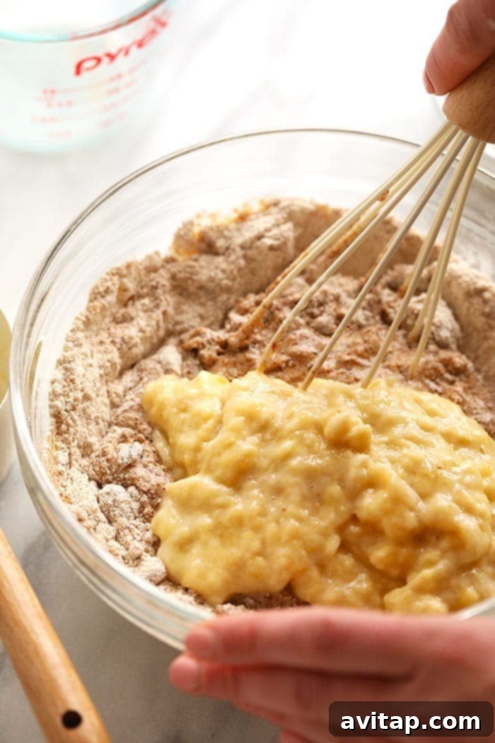 Close-up of vegan banana bread batter being mixed in a bowl, showcasing the wholesome ingredients.