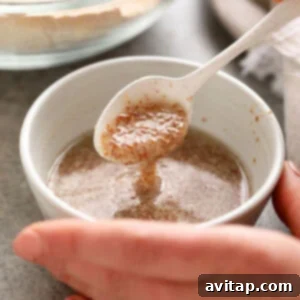 Close-up of a flax egg being mixed in a small bowl, showcasing its gelatinous texture.