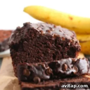 A slice of chocolate banana bread on a cutting board, rich and moist.