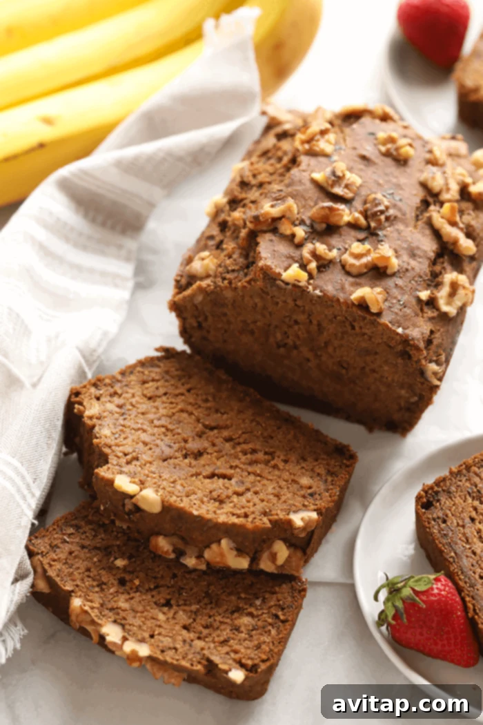 Beautifully sliced healthy vegan banana bread, showcasing its moist texture and wholesome ingredients.
