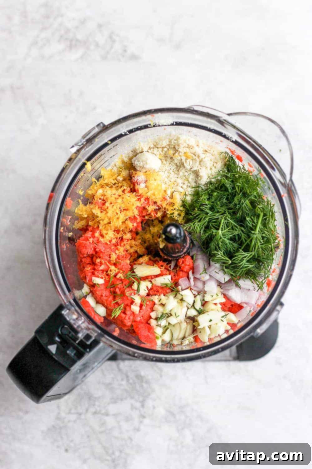 Salmon burger ingredients being combined in a food processor, ready to be pulsed.