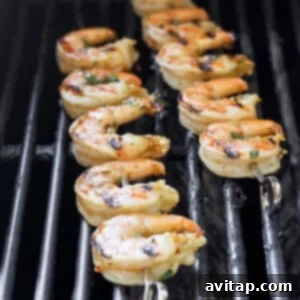 Shrimp on skewers grilling on a barbecue.