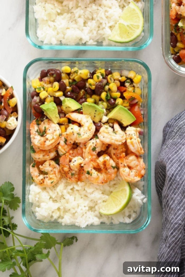 Fresh grilled shrimp meal prep bowl with rice and black bean corn salad.