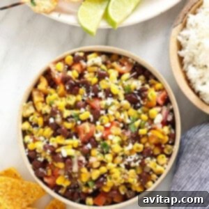 Colorful black bean and corn salad in a mixing bowl.