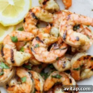Close-up of perfectly grilled shrimp on a plate.