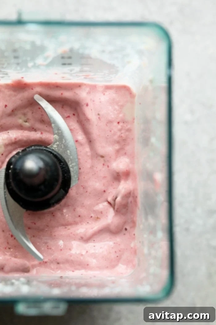 Creamy Strawberry Protein Shake 3 Close-up of a delicious protein smoothie in a glass, showcasing its creamy texture.