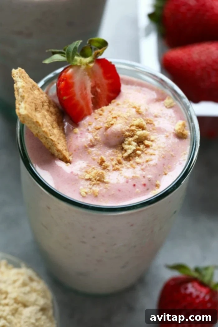 Creamy Strawberry Protein Shake 5 Three glasses of strawberry protein shake, one garnished with whipped cream and sprinkles, ready to be enjoyed.