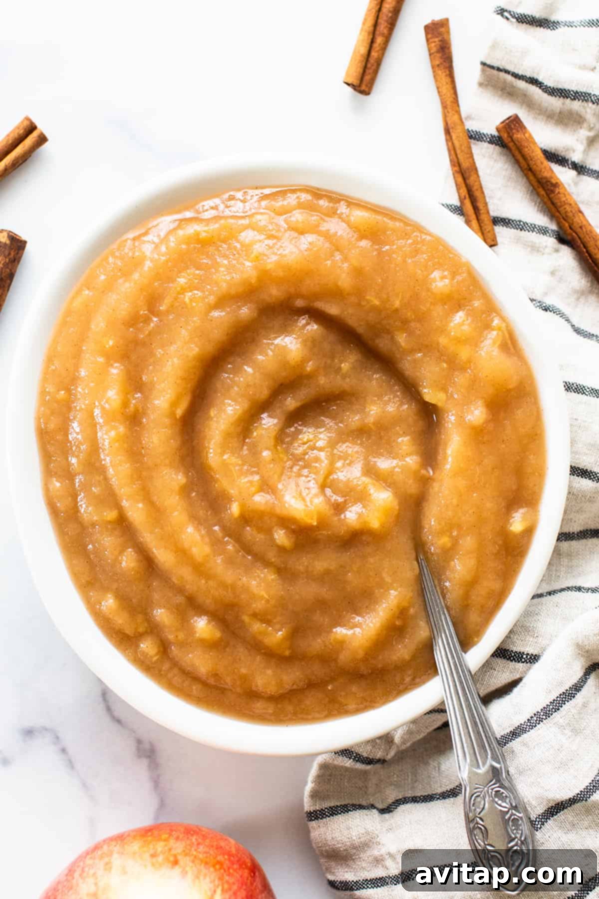 Easy Instant Pot Applesauce 2 Freshly made Instant Pot applesauce in a serving bowl, garnished with a cinnamon stick.
