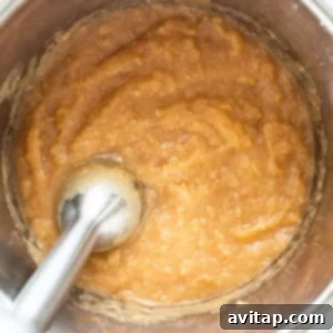 A bowl of batter with a spoon in it.