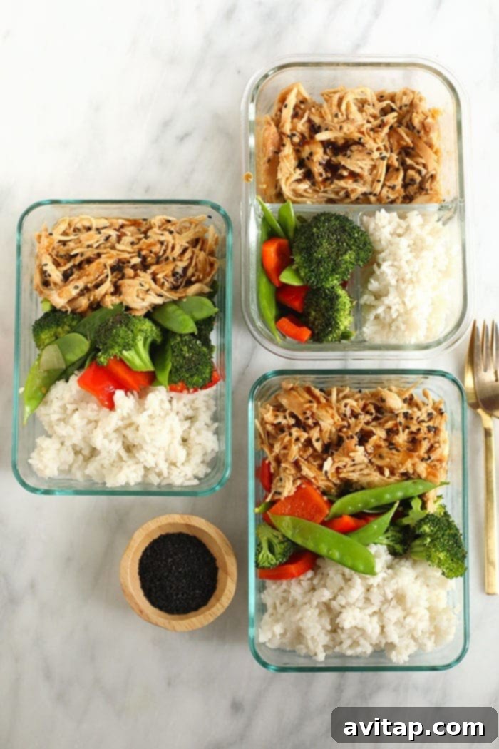 Crock Pot Teriyaki Chicken Meal Prep Bowls Four meal prep containers filled with teriyaki chicken, white rice, and colorful stir-fried vegetables, ready for the week.