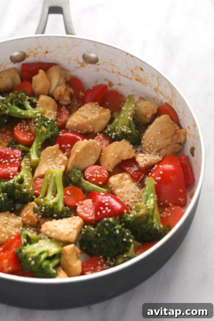 Finished chicken teriyaki stir fry in a pan, garnished with green onions