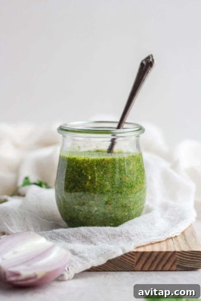 Freshly made chimichurri sauce in a glass jar, ready to be served