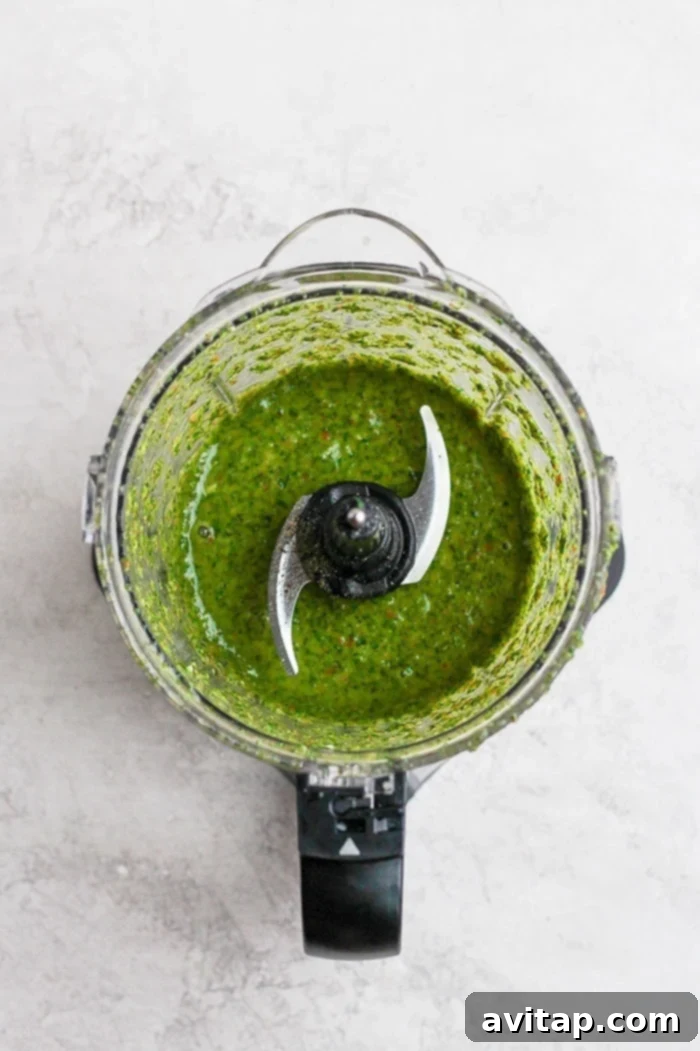 Blended chimichurri sauce inside a food processor bowl