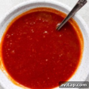 Homemade BBQ sauce stored in a glass Mason jar.